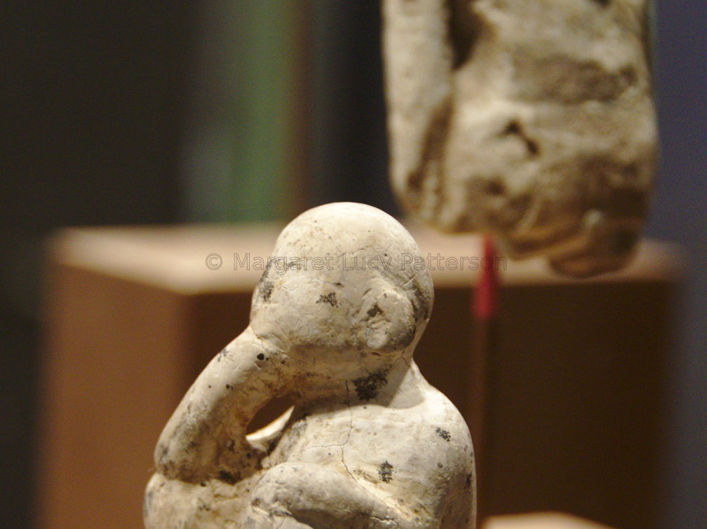 Figure of a Male Child with a Figure of a Standing Man in the Background