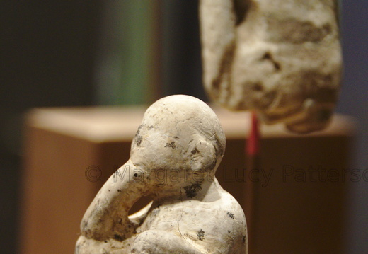 Figure of a Male Child with a Figure of a Standing Man in the Background