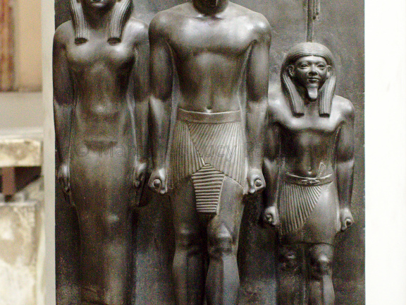Triad Statue of Menkaure Flanked by Hathor (left) and the Nome Deity of Thebes (right)