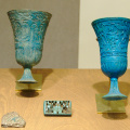 Two Relief Decorated Chalices, A Spacer and A Tile