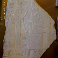 Stela Depicting Ahmose-Nefertari Behind the Seated God Amun with Her Son Amenhotep I Behind Her