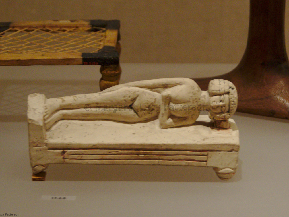 Model of Woman Lying on a Bed Using a Headrest
