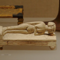 Model of Woman Lying on a Bed Using a Headrest